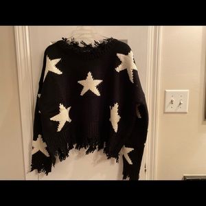 Black sweater with white stars.